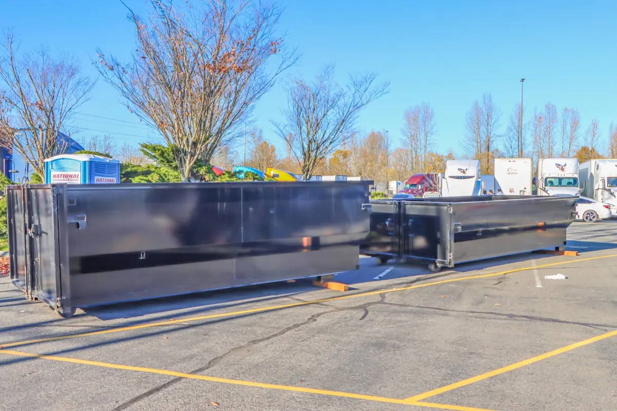 Professional dumpster rental service with roll-off container on residential driveway in Whitestown